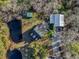 Aerial view of a beautiful property featuring a pond, homes, outbuildings, and lush greenery at 2724 A C Ln, Conway, SC 29526