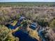Aerial view of estate featuring a large pond, multiple houses and outbuildings surrounded by dense woods at 2724 A C Ln, Conway, SC 29526