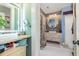 Stylish bathroom with wood paneled accent wall and round mirror over the sink at 2724 A C Ln, Conway, SC 29526