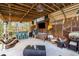Spacious covered outdoor entertainment area with bar, TV, comfortable seating, and rustic decor at 2724 A C Ln, Conway, SC 29526