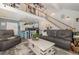 Open concept living room with staircase and view into the modern, rustic kitchen at 2724 A C Ln, Conway, SC 29526