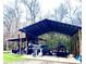 Metal outbuilding with a boat, trailer, and other recreational items parked inside at 2724 A C Ln, Conway, SC 29526