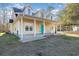 View of the inviting covered porch with white columns and a vibrant teal front door at 2724 A C Ln, Conway, SC 29526