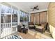 Relaxing screened porch with comfortable seating and ceiling fan at 2724 A C Ln, Conway, SC 29526