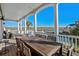 Inviting covered patio with marsh views features a dining table and chairs for outdoor relaxation and entertaining at 330 47Th Ave. N, North Myrtle Beach, SC 29582