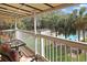 Relaxing covered balcony overlooking a lush lawn with view of the pool and palm trees at 340 Lands End Blvd. # 18, Myrtle Beach, SC 29572