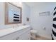 Well-lit bathroom featuring a white vanity, mirror, and a striped shower curtain at 340 Lands End Blvd. # 18, Myrtle Beach, SC 29572