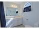 Bathroom features a white vanity, large mirror, window, and ample lighting at 340 Lands End Blvd. # 18, Myrtle Beach, SC 29572