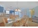 Well-lit dining room with seating for six, and a kitchen area with breakfast bar in the background at 340 Lands End Blvd. # 18, Myrtle Beach, SC 29572