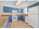 Bright kitchen with blue cabinets, white appliances, and laminate countertops and floors at 340 Lands End Blvd. # 18, Myrtle Beach, SC 29572