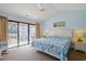 Light-filled main bedroom featuring a balcony, shell patterned bedding, and a white paneled headboard at 340 Lands End Blvd. # 18, Myrtle Beach, SC 29572