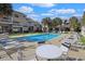 Community swimming pool surrounded by lounge chairs and palm trees at 340 Lands End Blvd. # 18, Myrtle Beach, SC 29572