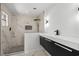 Stylish bathroom with marble tiled shower, black hardware, and floating vanity at 3807 Casey St., Loris, SC 29569