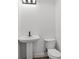 Compact bathroom featuring pedestal sink, modern lighting, and clean fixtures at 3807 Casey St., Loris, SC 29569