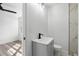 Bathroom view showcasing grey vanity and modern fixtures, opening to a bright bedroom at 3807 Casey St., Loris, SC 29569