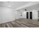 Spacious bedroom with wood-look floors, modern black doors, and bright natural light at 3807 Casey St., Loris, SC 29569