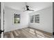 Bright bedroom with wood-look flooring, ceiling fan, and natural light at 3807 Casey St., Loris, SC 29569