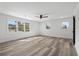 Well-lit bedroom with multiple windows, ceiling fan, and stylish wood-look flooring at 3807 Casey St., Loris, SC 29569
