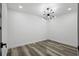 Minimalist bedroom featuring modern light fixture and wood-look flooring at 3807 Casey St., Loris, SC 29569