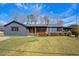 Charming single-story home with a well-manicured lawn, gray painted brick, and inviting front porch at 3807 Casey St., Loris, SC 29569