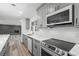 Open-concept eat-in kitchen with gray cabinets, stainless appliances and updated countertops at 3807 Casey St., Loris, SC 29569