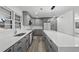 Bright eat-in kitchen featuring gray cabinets, stainless appliances, quartz countertops and an island at 3807 Casey St., Loris, SC 29569
