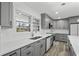Bright kitchen featuring gray cabinets, quartz countertops, stainless appliances and natural light at 3807 Casey St., Loris, SC 29569