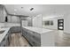 Eat-in kitchen featuring gray cabinets, quartz countertops, stainless appliances and an island at 3807 Casey St., Loris, SC 29569
