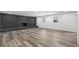 Spacious living room featuring a painted brick fireplace and modern vinyl plank flooring at 3807 Casey St., Loris, SC 29569