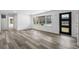Bright living room featuring sleek vinyl plank flooring, neutral paint, and a large picture window at 3807 Casey St., Loris, SC 29569