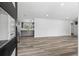 Open-concept living area with sleek vinyl plank flooring and views into the modern gray kitchen at 3807 Casey St., Loris, SC 29569