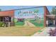 Community mural in Loris SC, featuring a tractor and farmland scene at 3807 Casey St., Loris, SC 29569