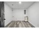 Bright utility room featuring gray vinyl flooring, a modern water heater, and hookups for a washer and dryer at 3807 Casey St., Loris, SC 29569