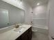 Bathroom boasts elegant bronze fixtures, a vanity with a quartz countertop, and a bathtub at 4000 Braid Ct., Myrtle Beach, SC 29588