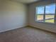 Bright bedroom features carpeted floors and a window with a view of the outdoors at 4000 Braid Ct., Myrtle Beach, SC 29588