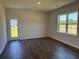 Cozy bedroom with wood floors, a window and an exit door to the yard at 4000 Braid Ct., Myrtle Beach, SC 29588