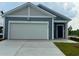 Charming home featuring a two-car garage, blue siding, and well-manicured lawn at 4000 Braid Ct., Myrtle Beach, SC 29588