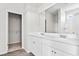 Bright bathroom featuring dual sinks, white cabinets, large mirror and walk in shower at 439 Falling Leaf Loop, Myrtle Beach, SC 29588