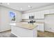 Bright kitchen with white cabinets, stainless steel appliances, and a granite countertop island at 439 Falling Leaf Loop, Myrtle Beach, SC 29588