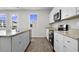 Bright kitchen featuring white cabinets, stainless steel appliances, and stone countertops at 439 Falling Leaf Loop, Myrtle Beach, SC 29588