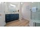 Bright bathroom with a modern vanity, wood-look floors, and tiled glass shower for a spa-like feel at 4239 Rivergate Ln., Little River, SC 29566