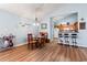 Open-concept dining area with view of the kitchen featuring bar seating and stainless steel appliances at 4239 Rivergate Ln., Little River, SC 29566