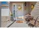 Inviting front porch with a decorative wreath, cozy seating, and pleasant details; ideal for relaxation at 4239 Rivergate Ln., Little River, SC 29566
