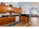 Kitchen with wood cabinets and black countertops, opens into a brightly lit living space at 4239 Rivergate Ln., Little River, SC 29566