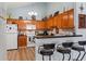 Kitchen features wood cabinetry, black countertops, and a breakfast bar with barstool seating at 4239 Rivergate Ln., Little River, SC 29566