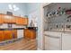 Kitchen with a view of the adjacent laundry room featuring a washing machine and shelving at 4239 Rivergate Ln., Little River, SC 29566