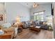 Bright living room features vaulted ceilings, a ceiling fan and a comfortable gray sectional sofa at 4239 Rivergate Ln., Little River, SC 29566