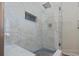 Sleek shower with glass door, marble tile, and accent niche for toiletries at 4239 Rivergate Ln., Little River, SC 29566
