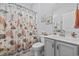 Bathroom with printed shower curtain and gray vanity at 430 7Th Ave. S, North Myrtle Beach, SC 29582