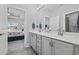 Bathroom with double sinks and an open doorway to the bedroom at 430 7Th Ave. S, North Myrtle Beach, SC 29582